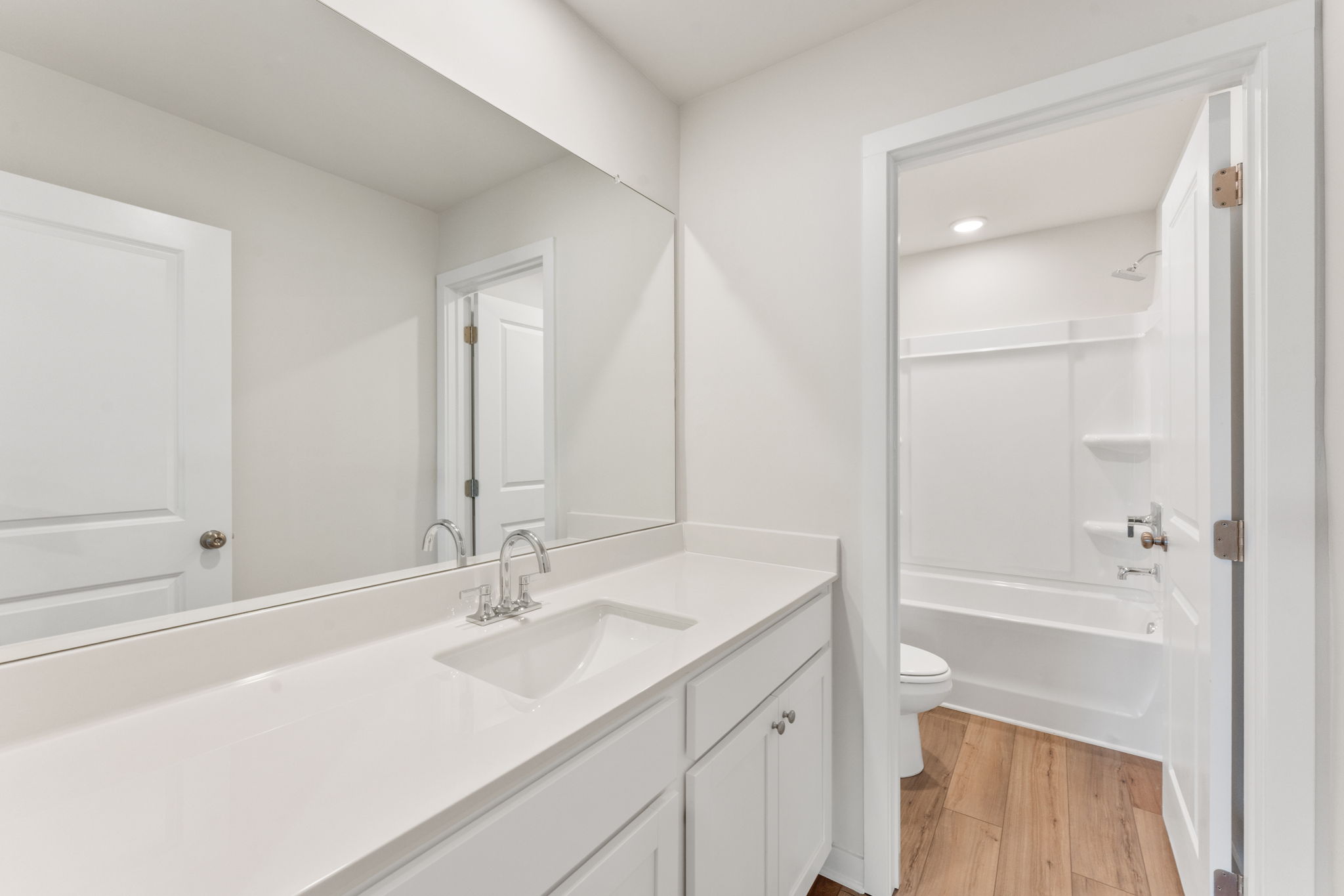 A bathroom with a tub sink and toilet.