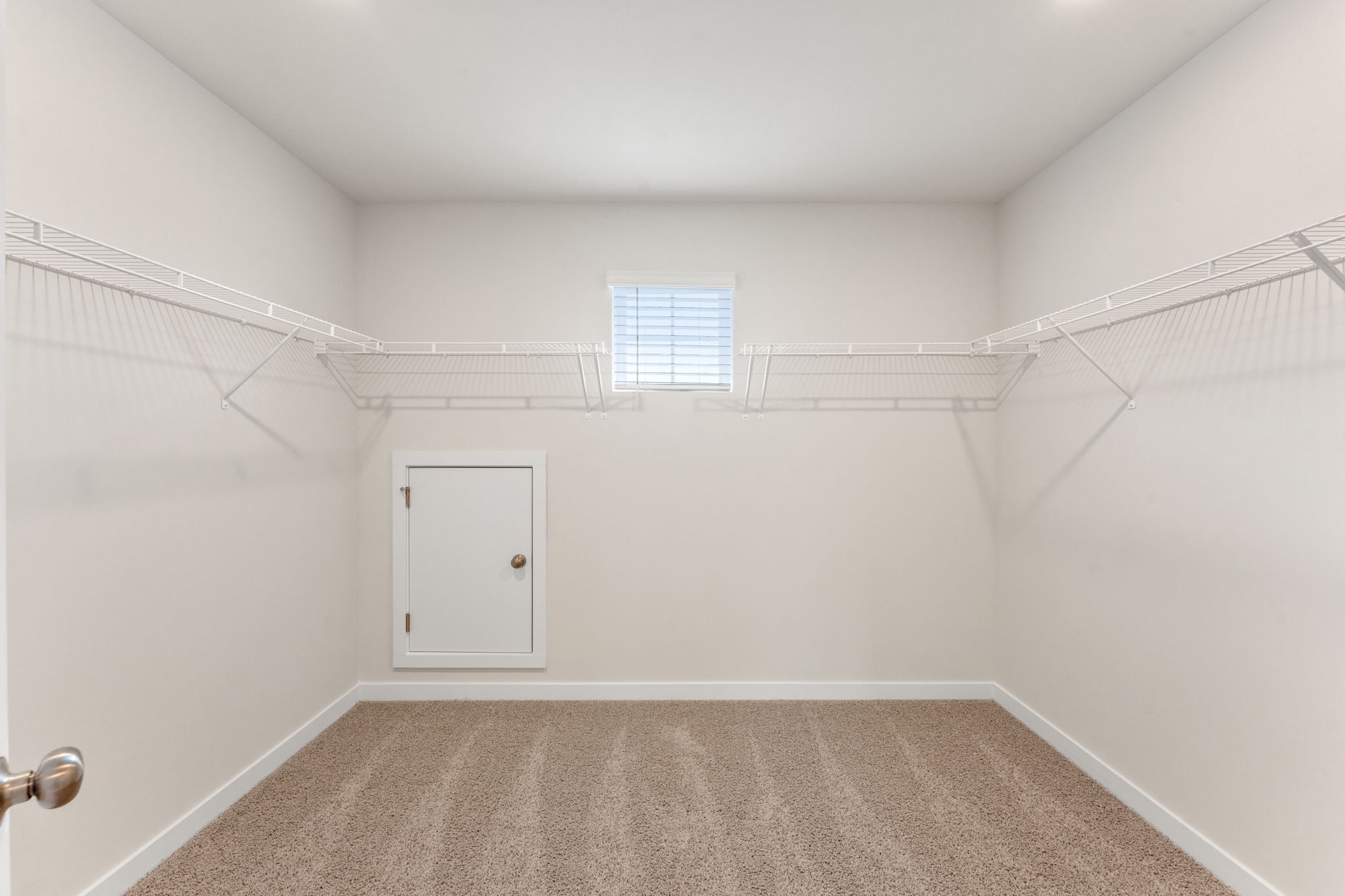A white room with a white door.