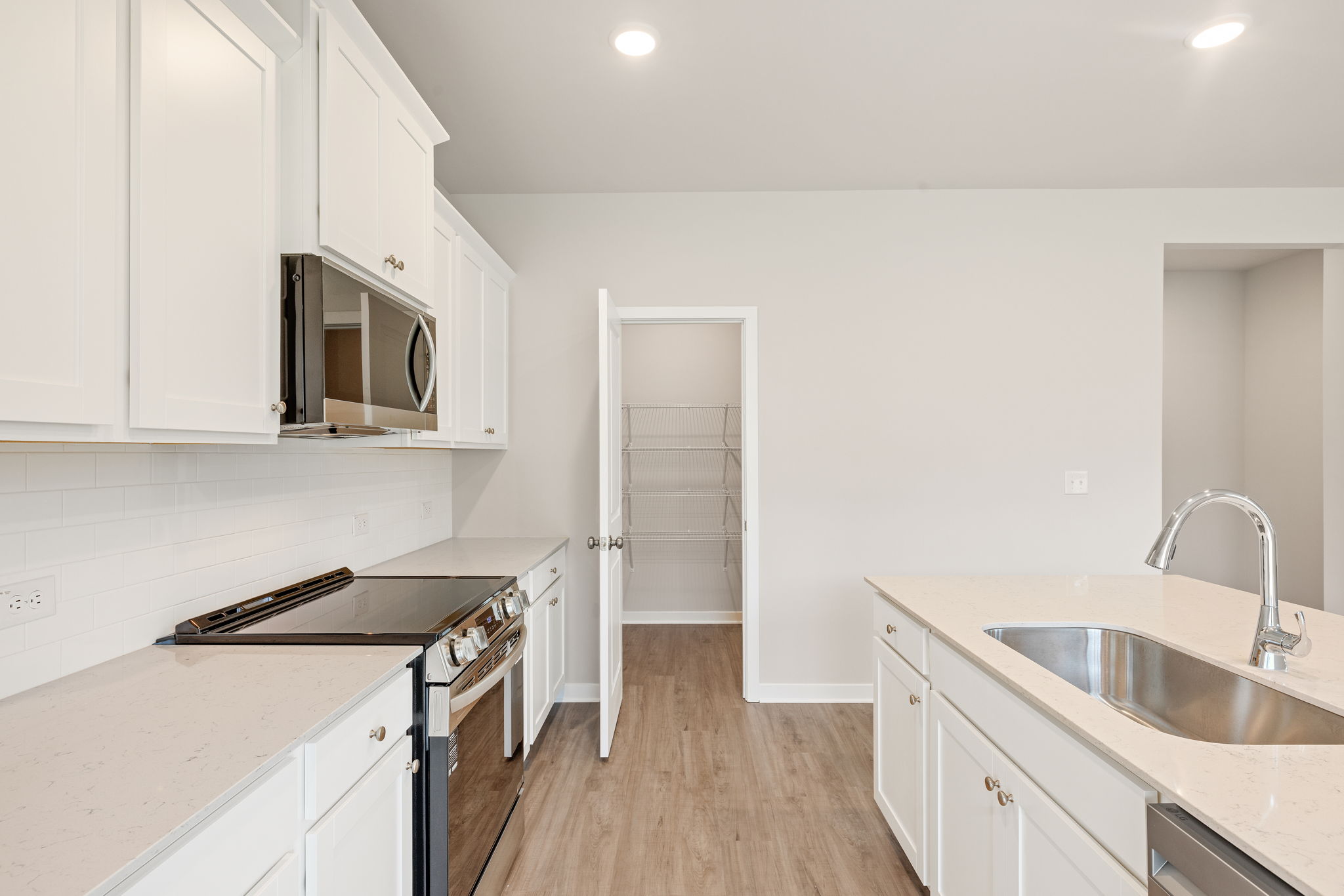 A kitchen with white cabinets.