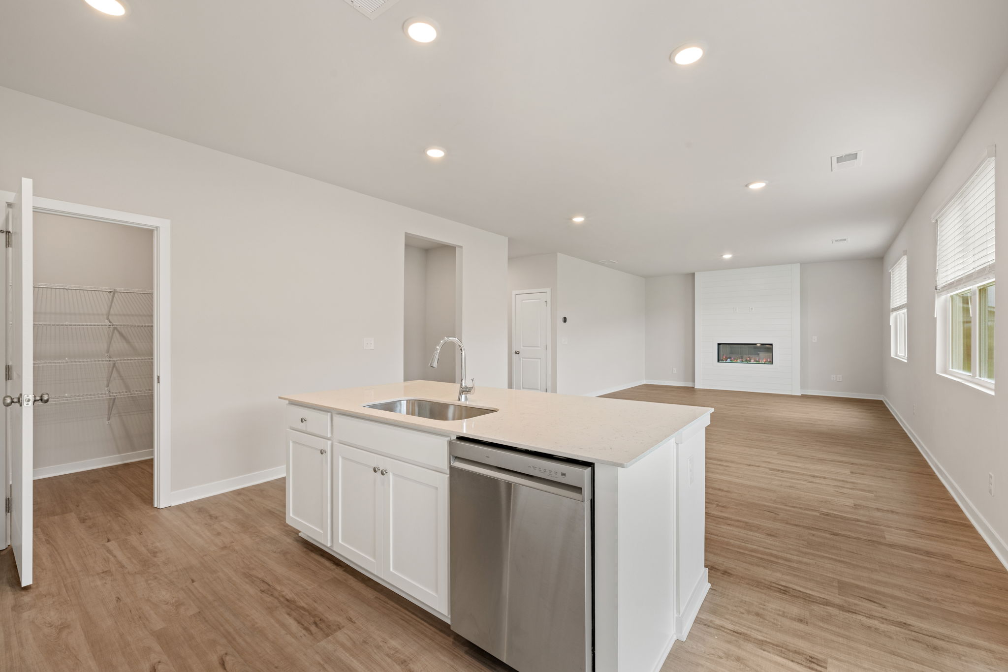 A kitchen with white cabinets.