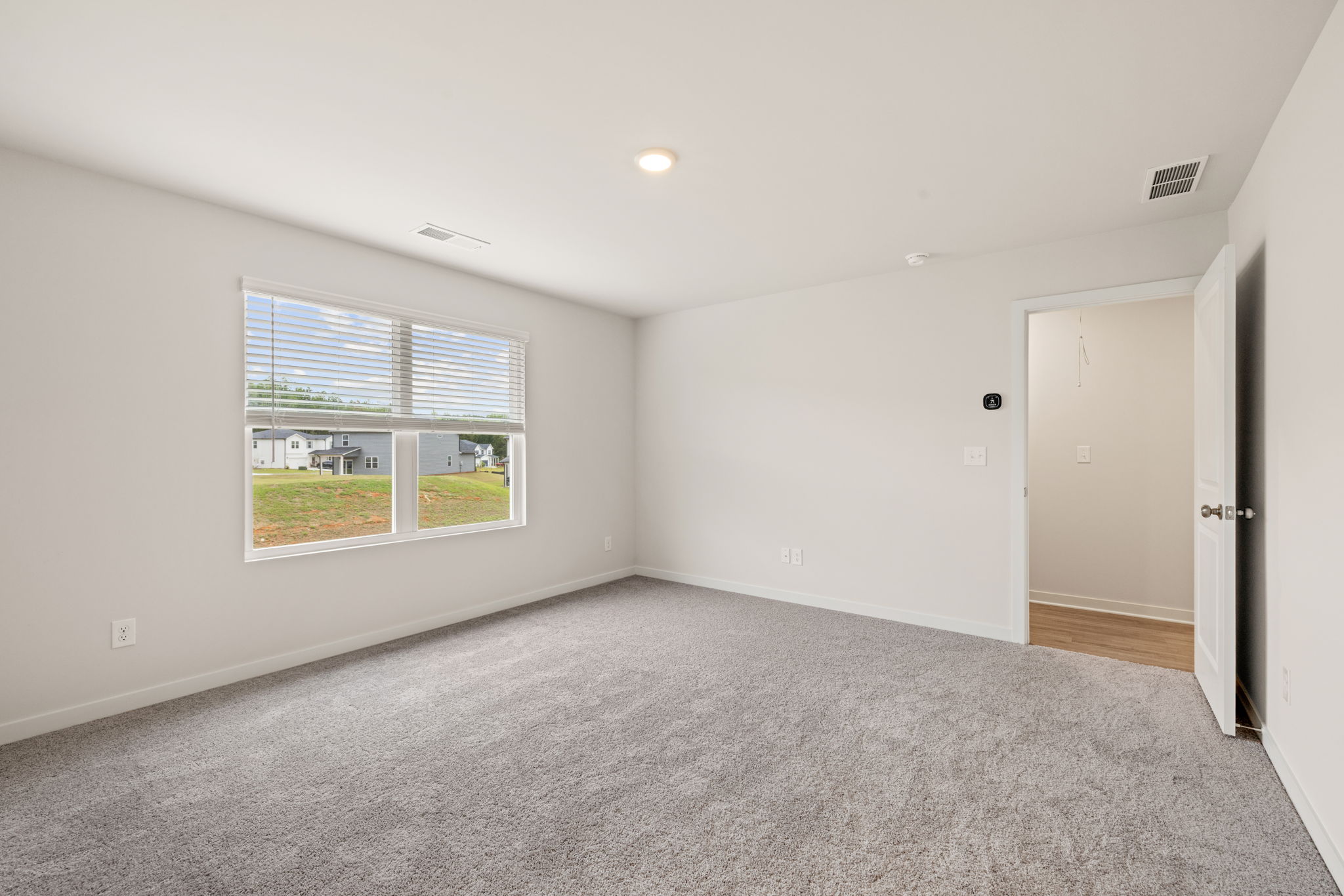 A room with a window and a door.