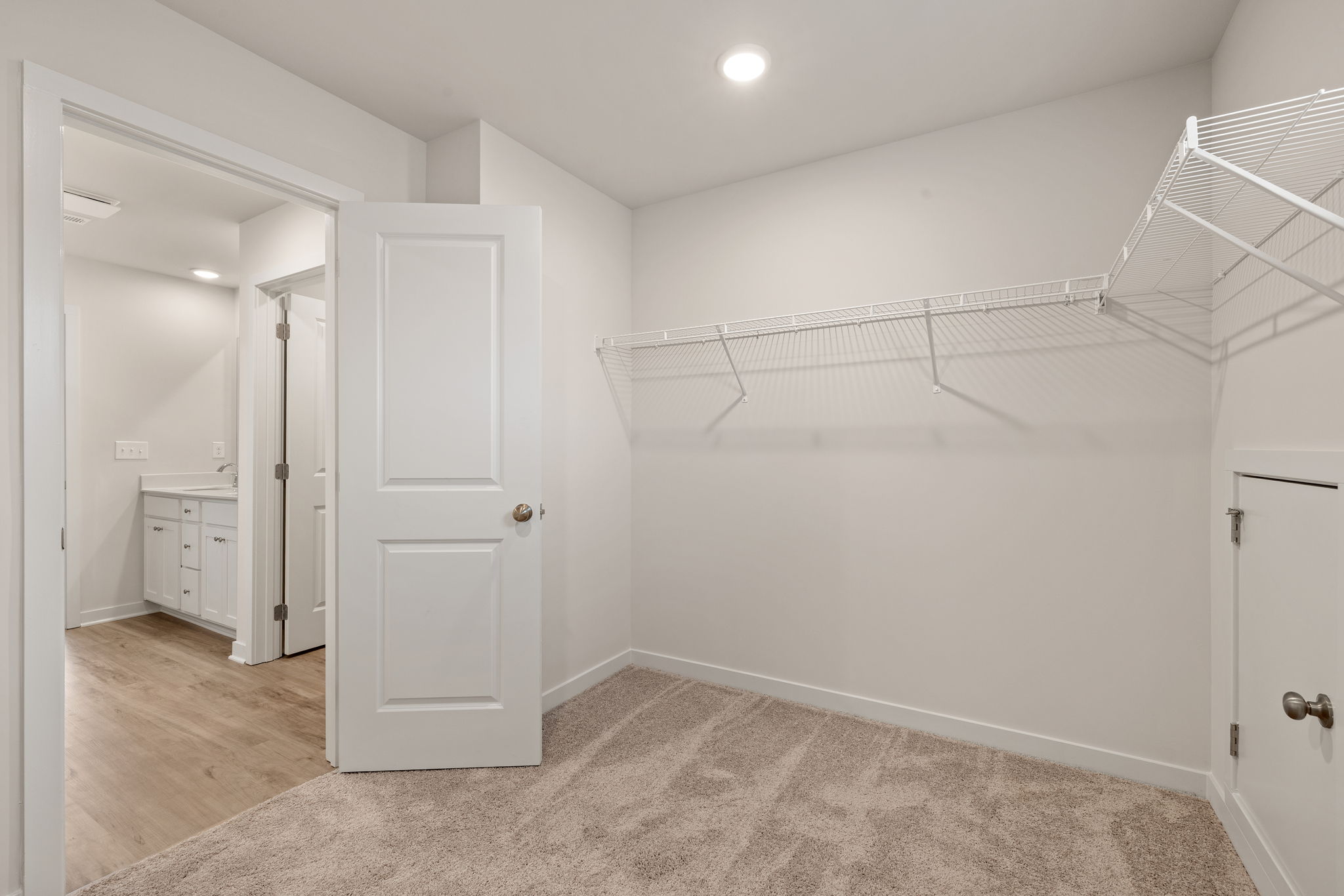A room with white walls and a wood floor.