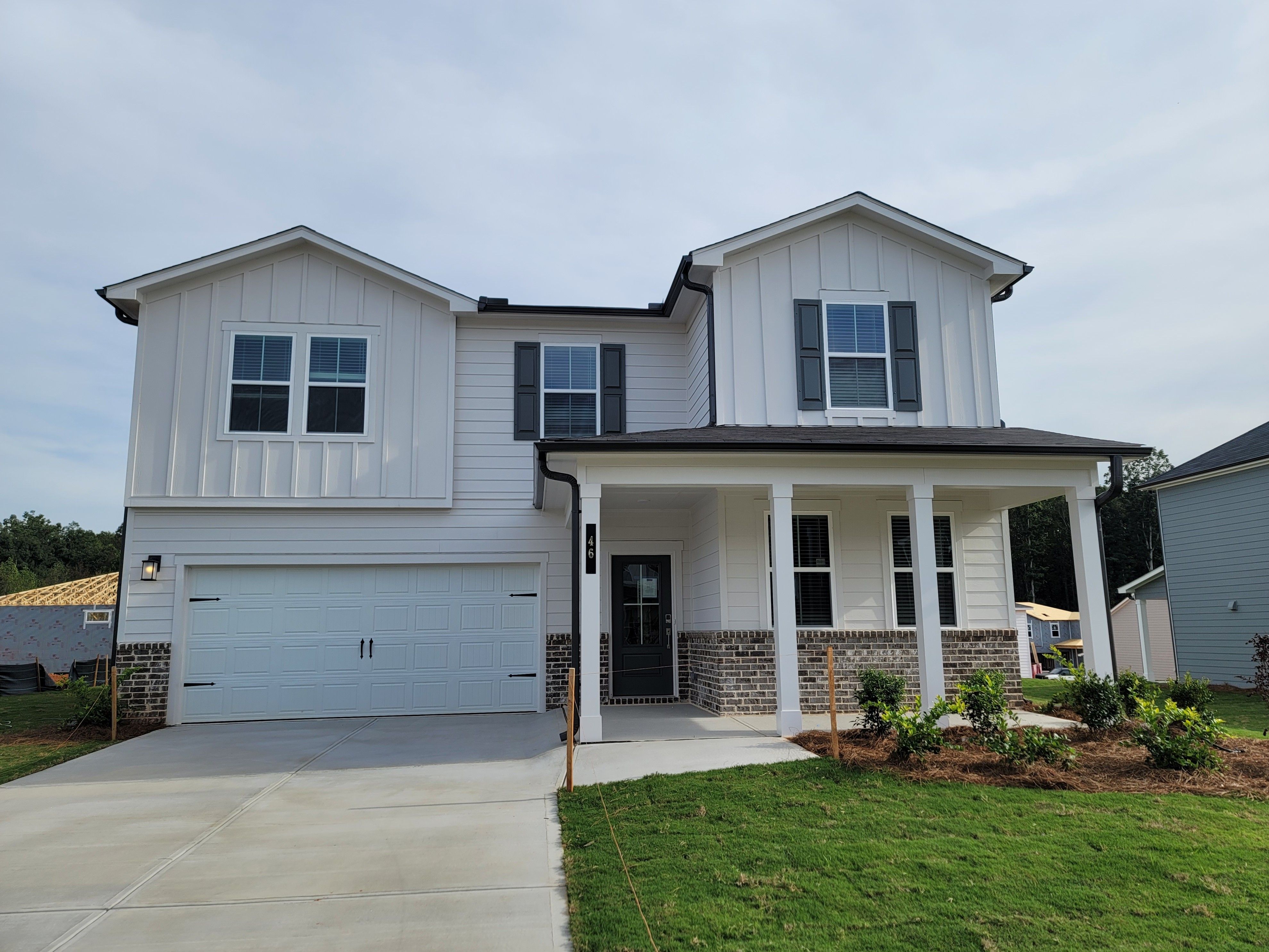 A white house with a garage.