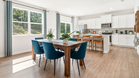 A kitchen with a table and chairs.