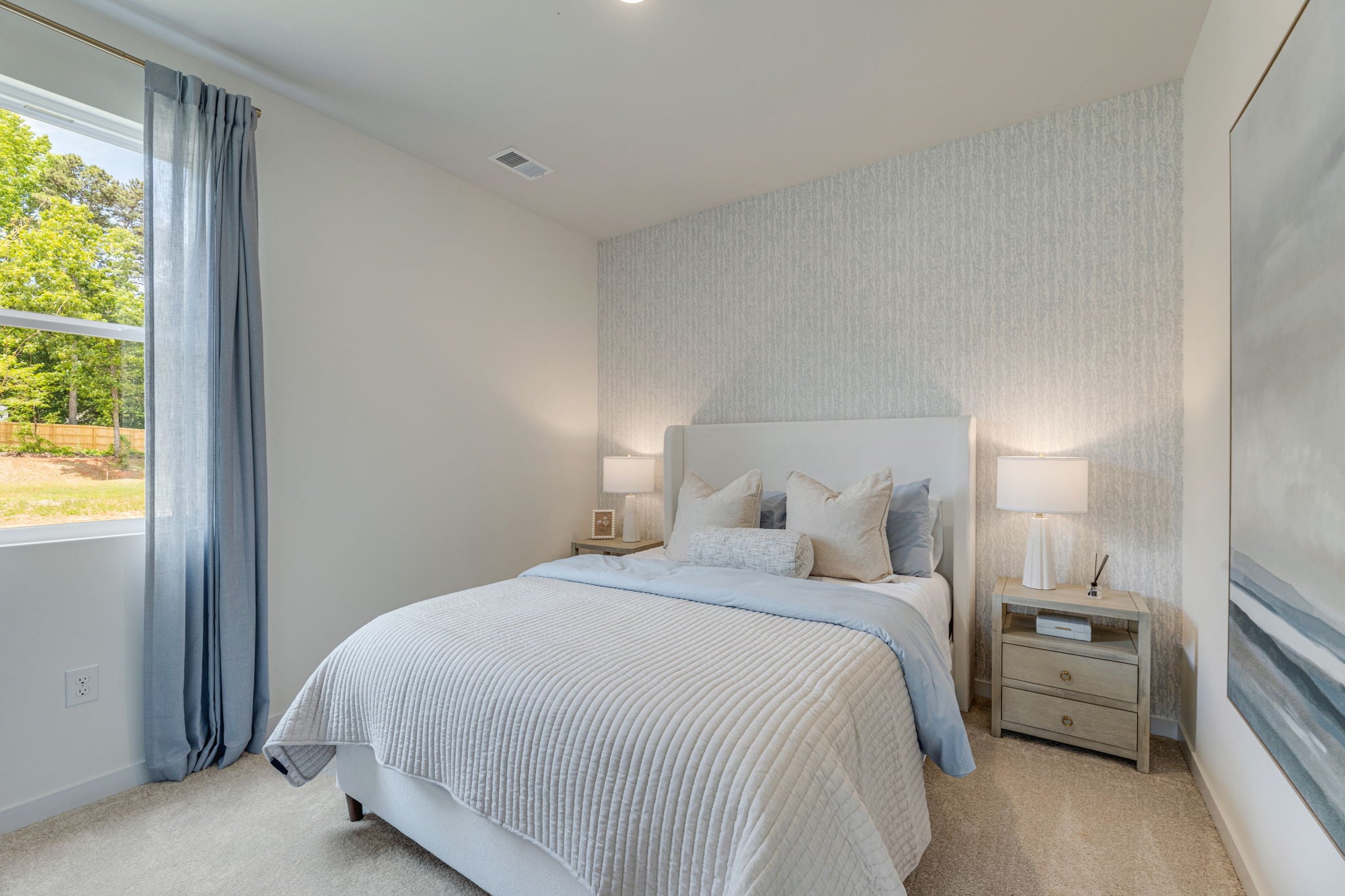 A bedroom with a large window.