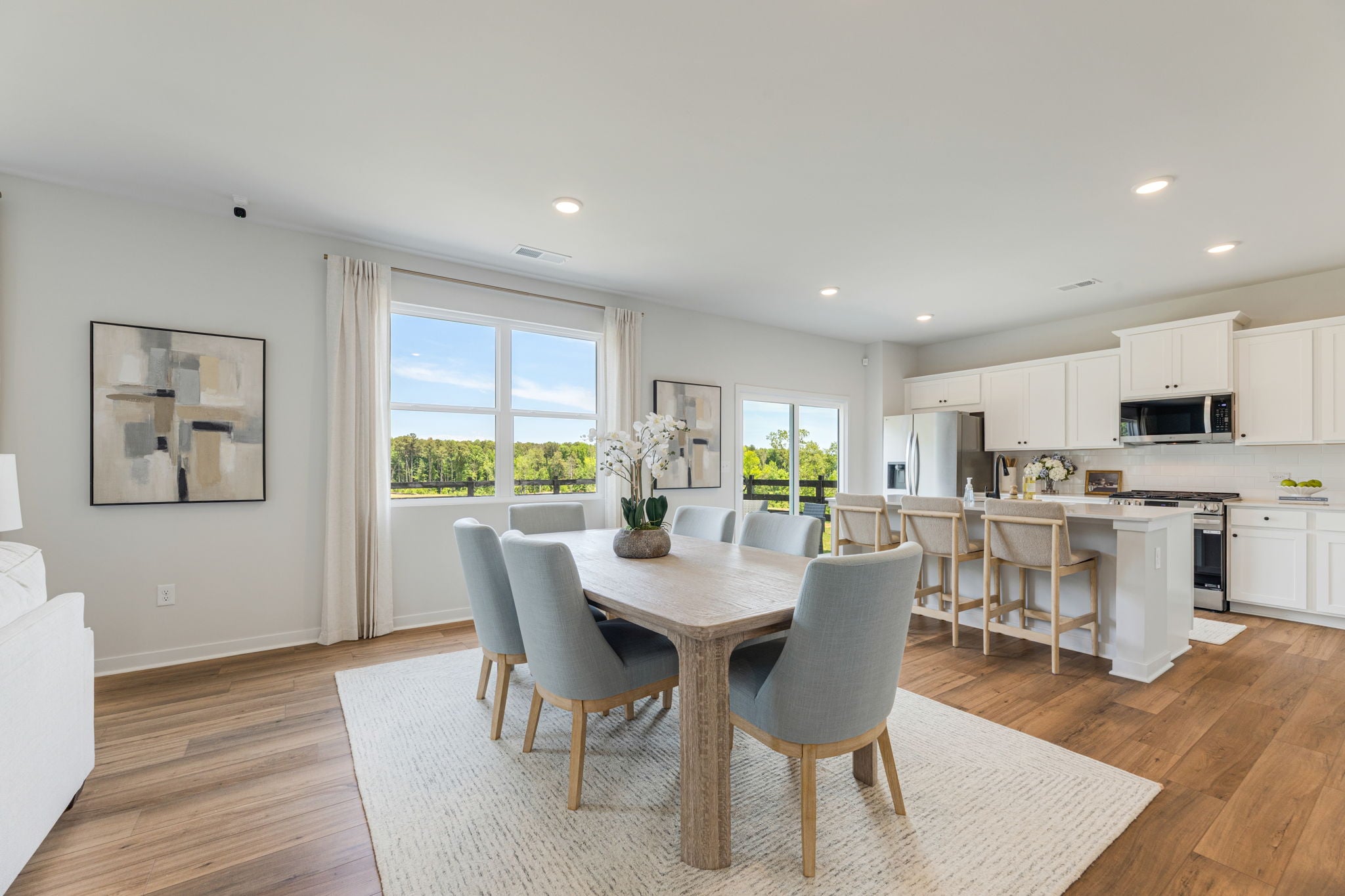 A large kitchen with a dining table.