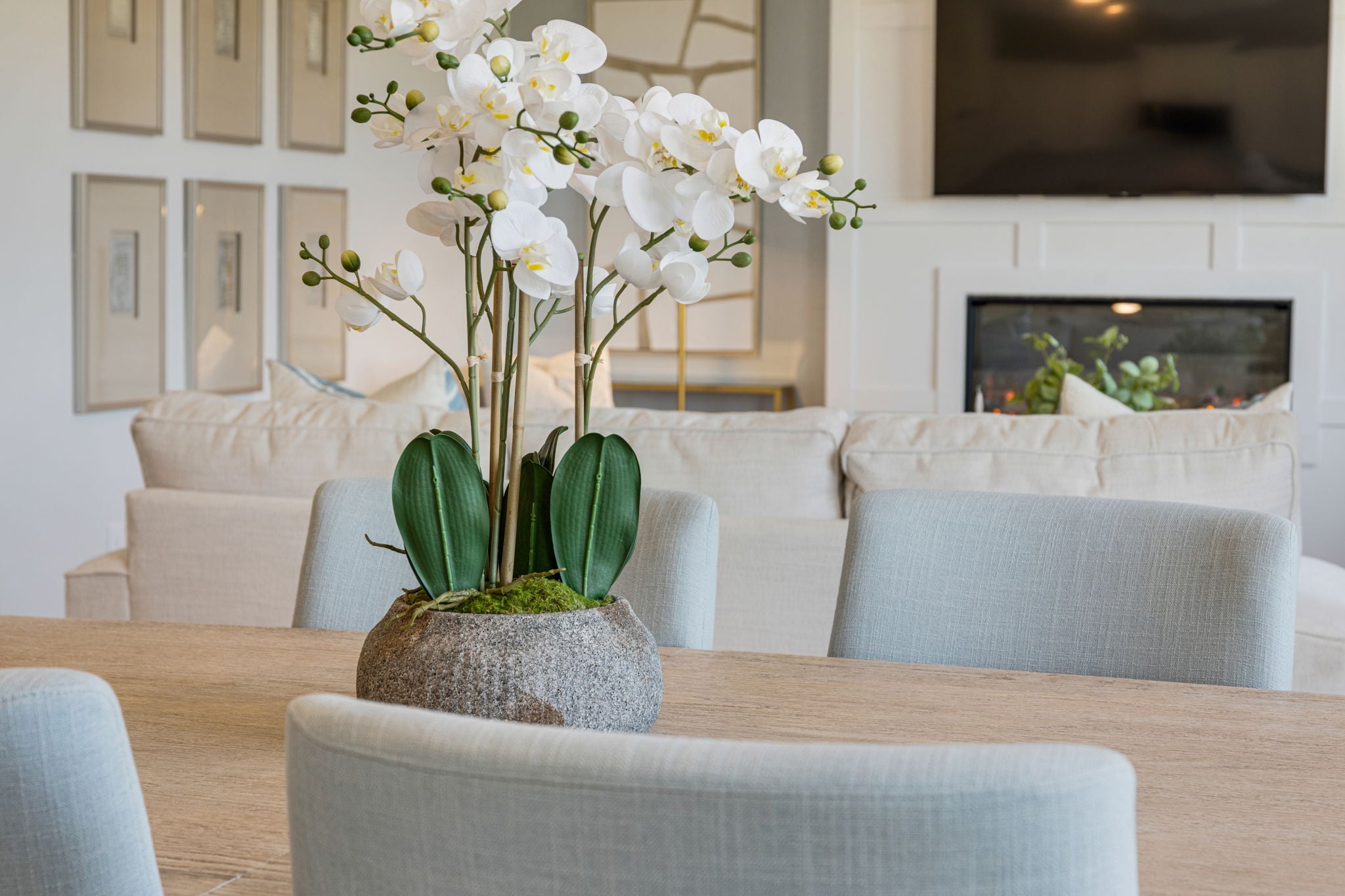 A vase with white flowers on a table.