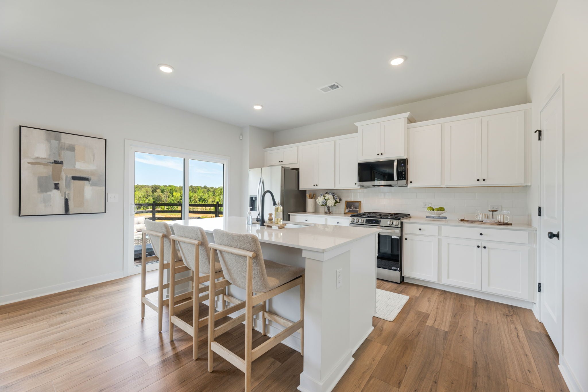 A kitchen with white cabinets.