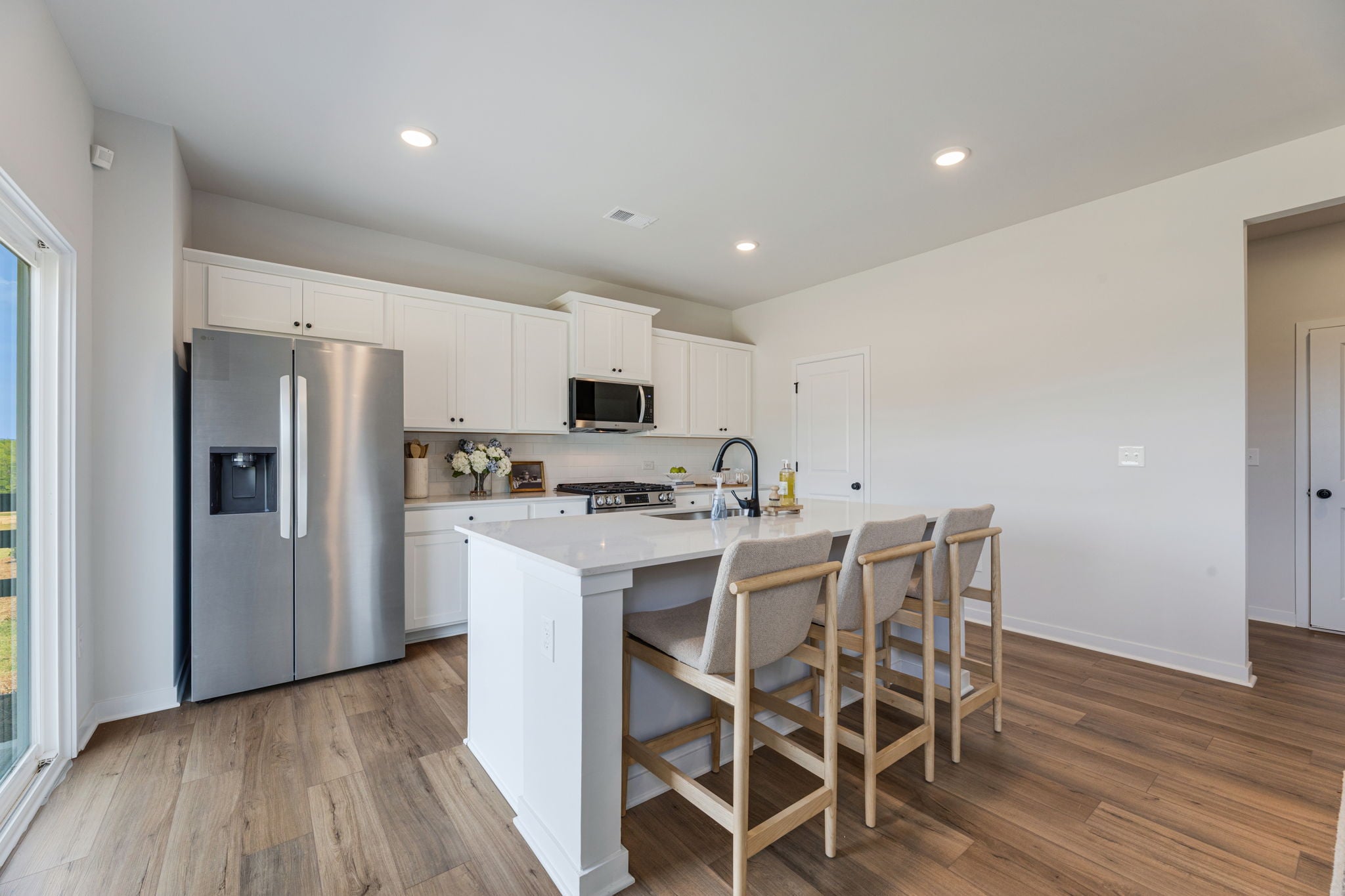 A kitchen with white cabinets.