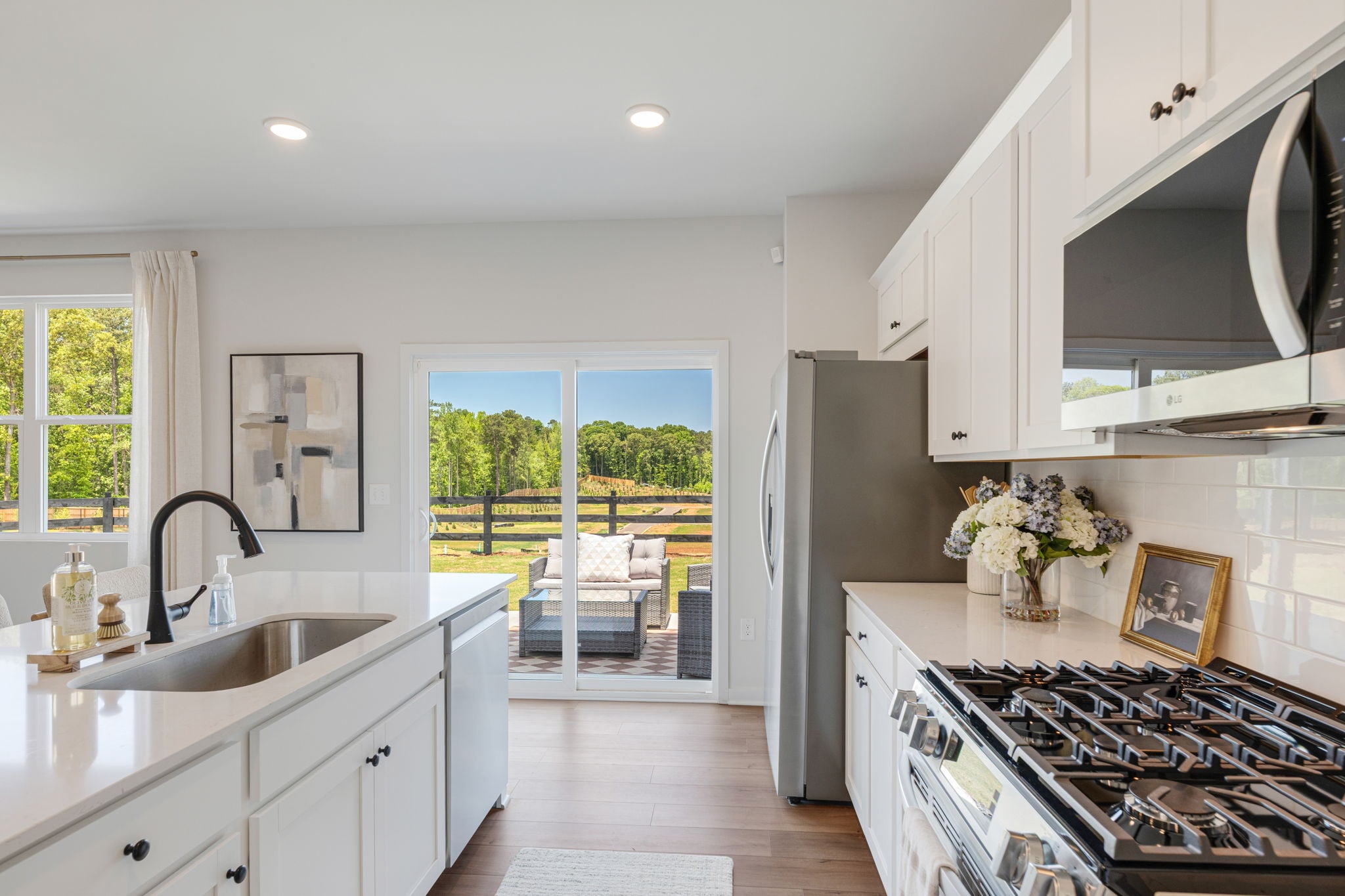 A kitchen with a large glass door.