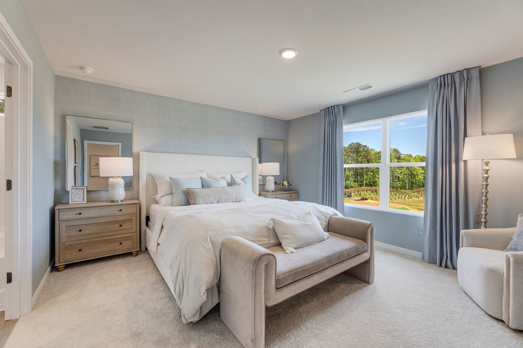 A bedroom with a large window.