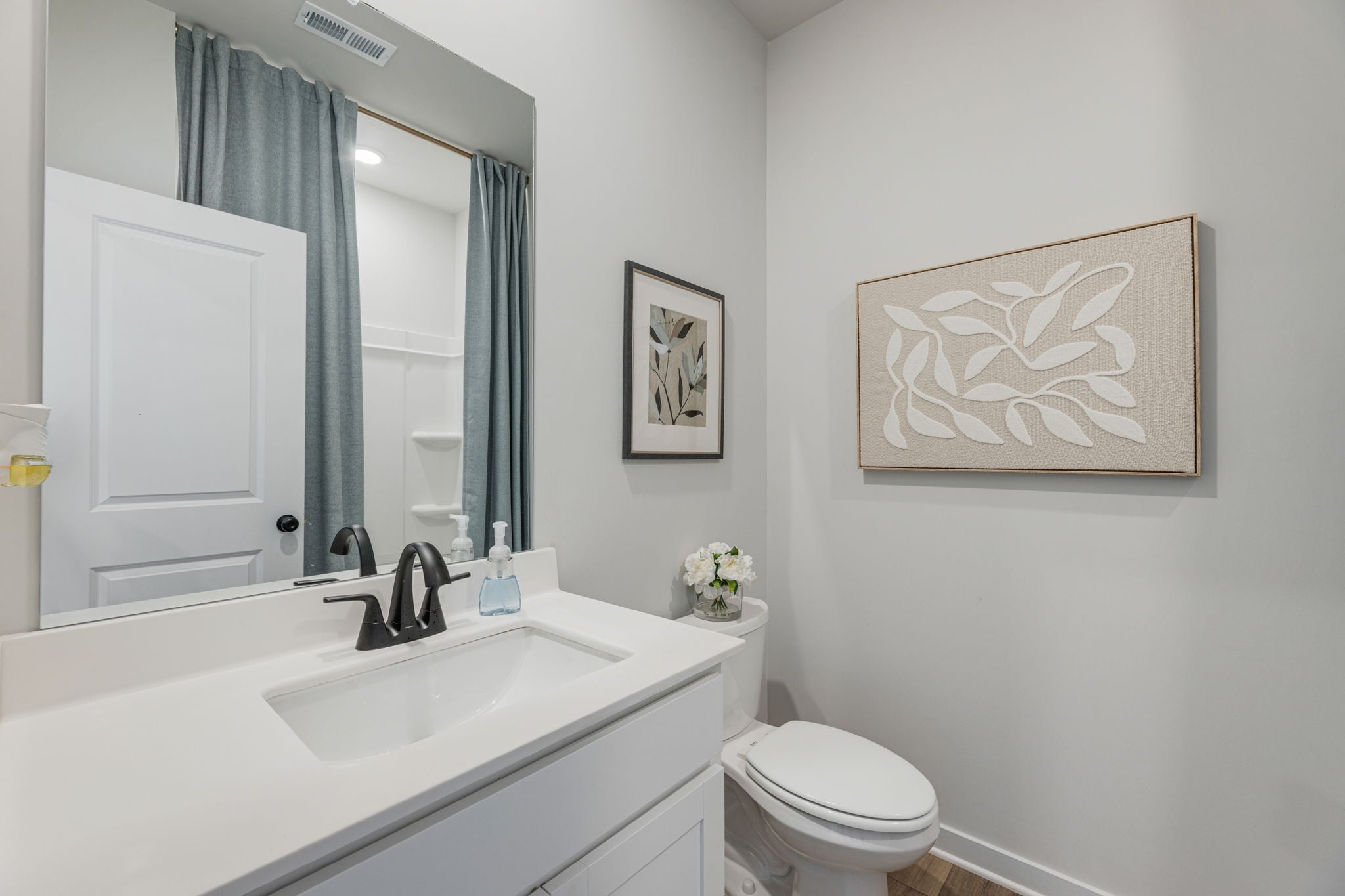 A bathroom with a sink and a toilet.