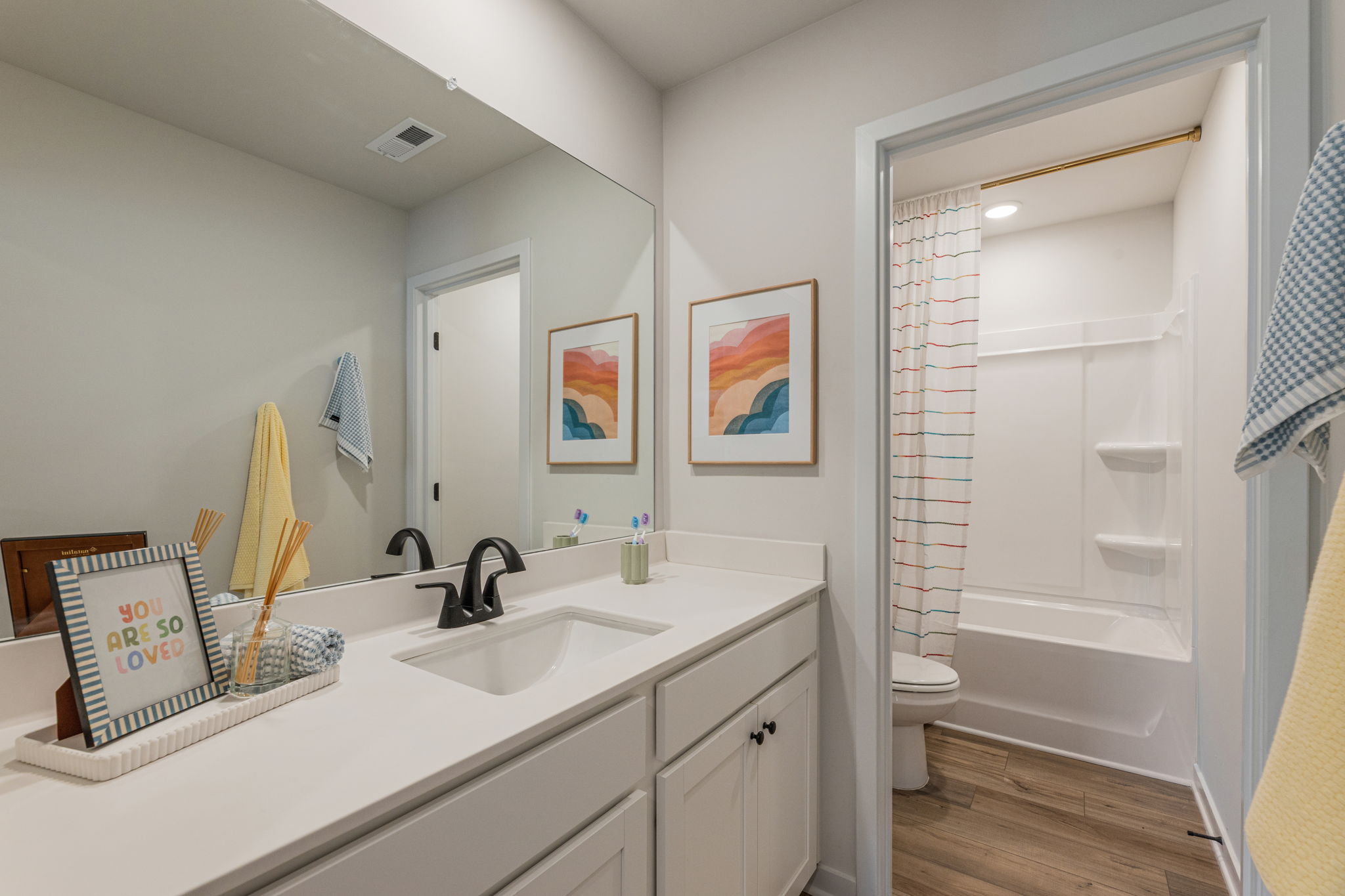 A bathroom with a sink and a shower.