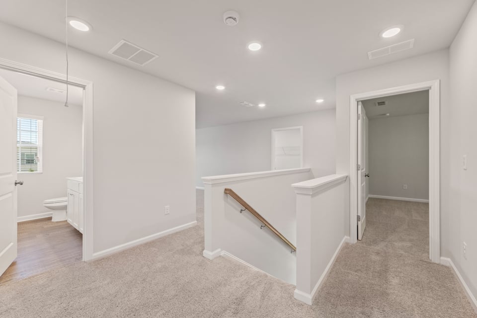 A bathroom with a tub and toilet.