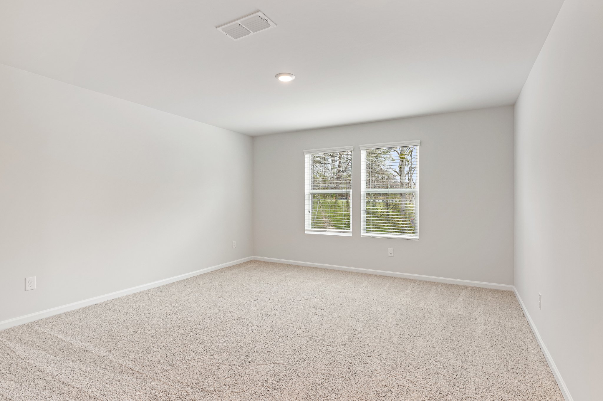 A room with a window and a carpet.