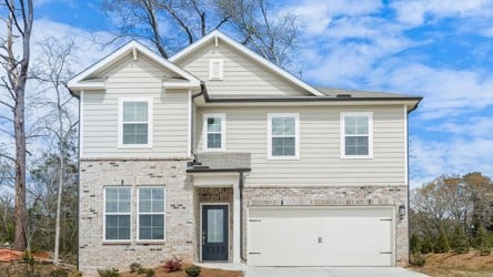 A white house with a garage.