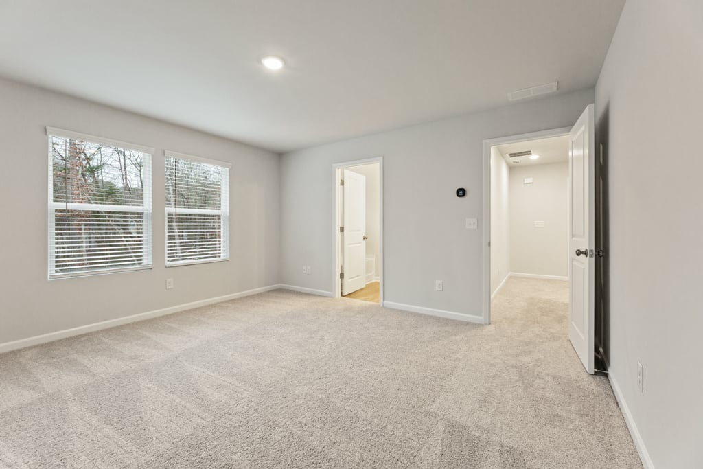 A room with white walls and a carpeted floor.