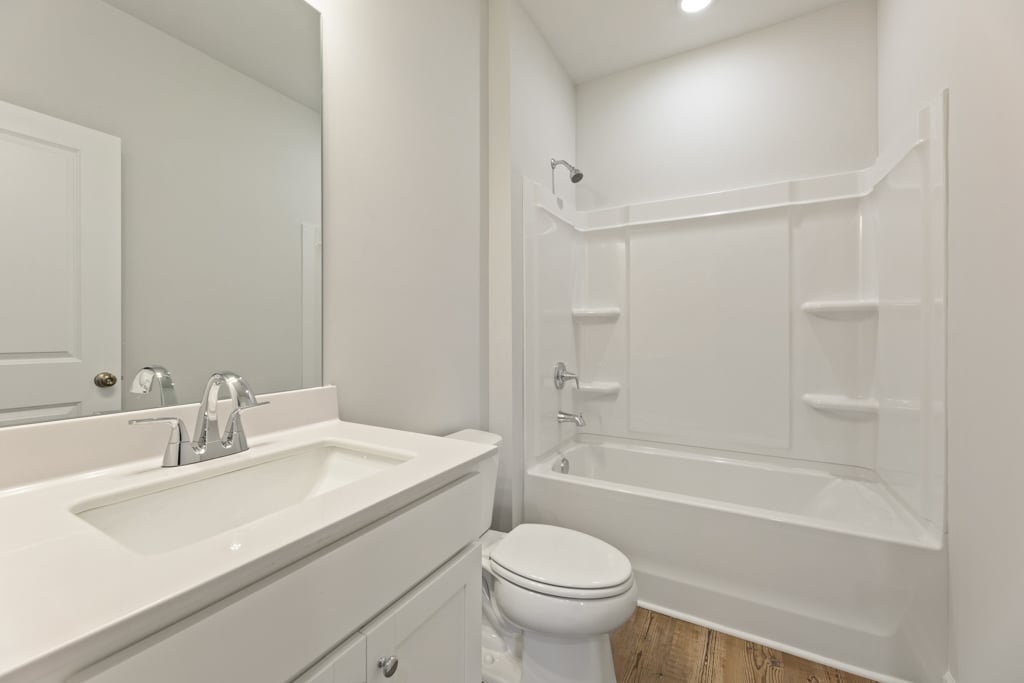 A bathroom with a tub sink and toilet.