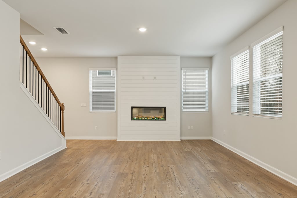 A room with a wood floor and white walls.