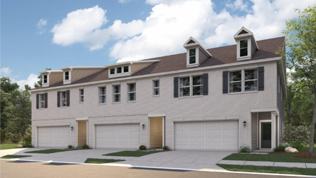 A large white house with garages.