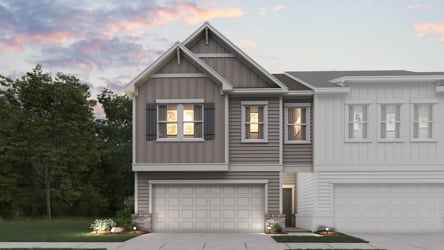 A house with a garage and trees.