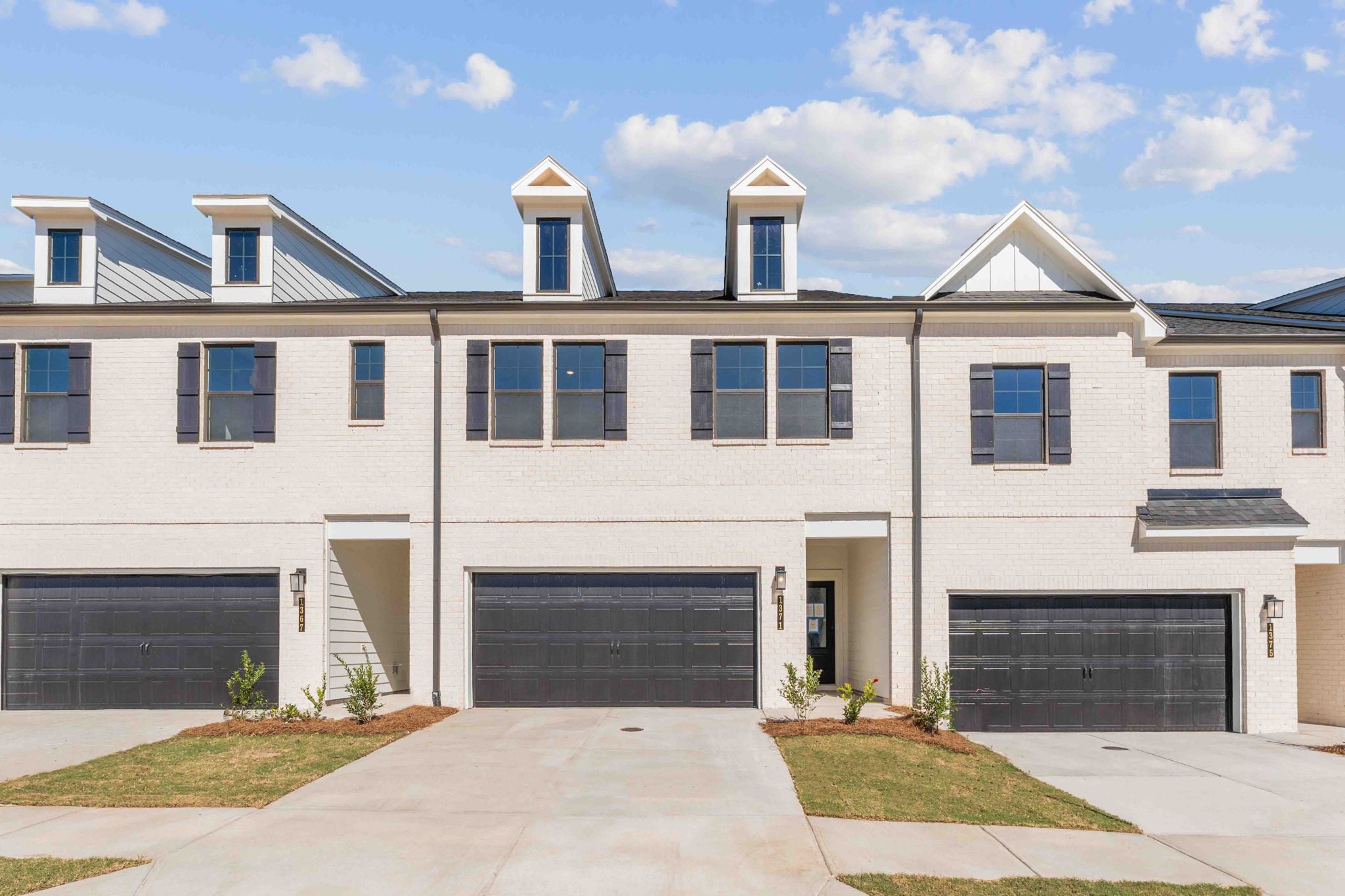 A white building with a garage.