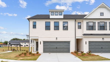 A white building with a garage.