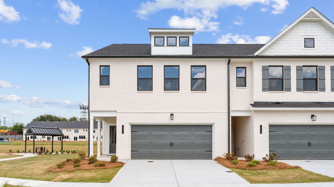 A white building with a garage.