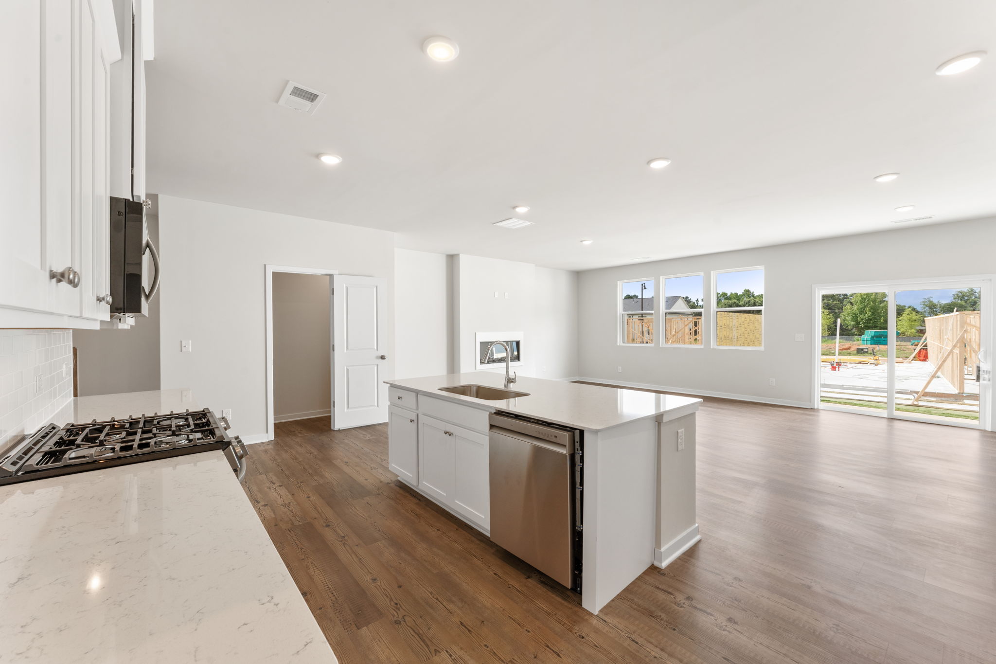 A kitchen with white cabinets.