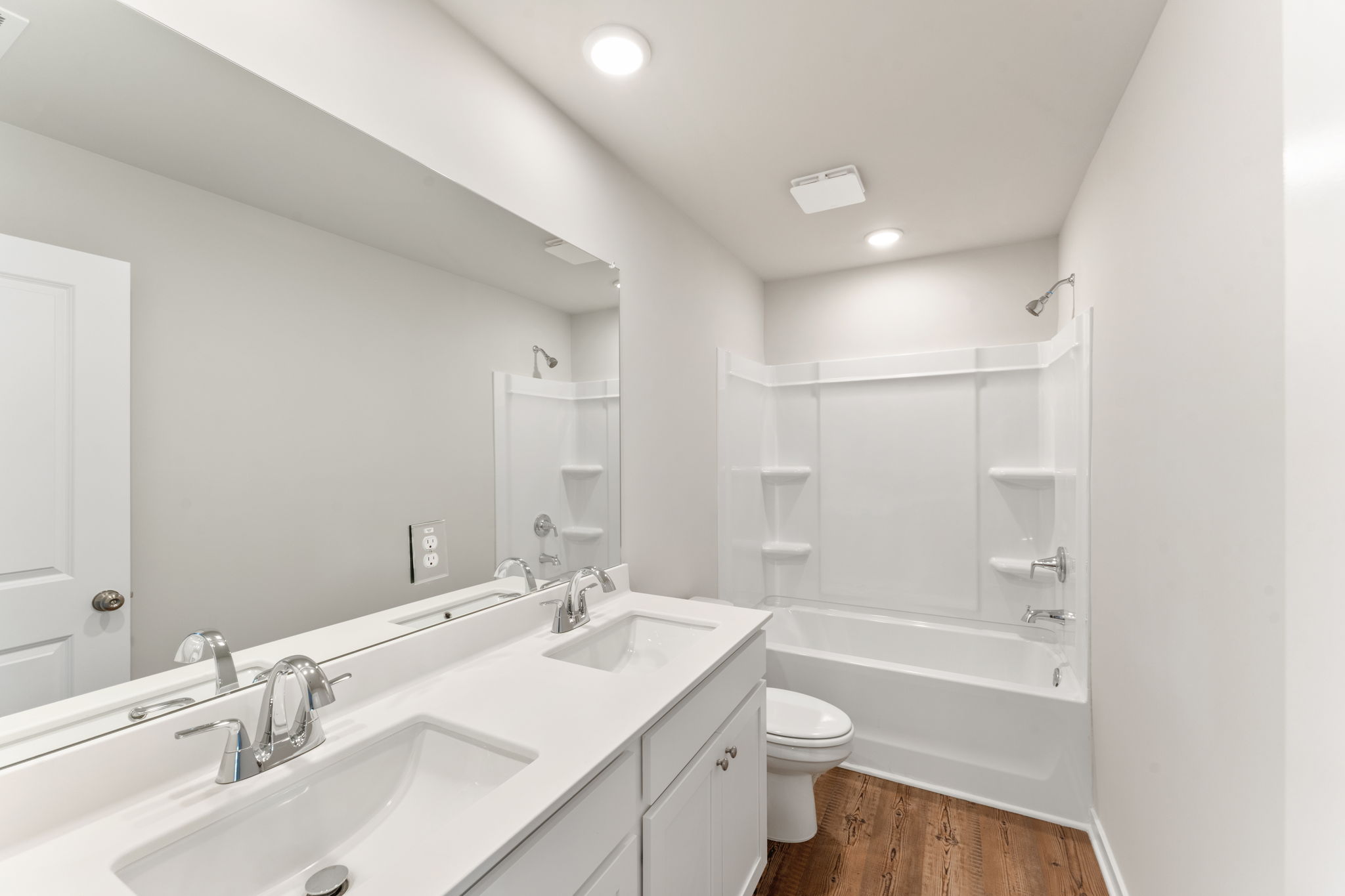 A bathroom with a tub sink and toilet.