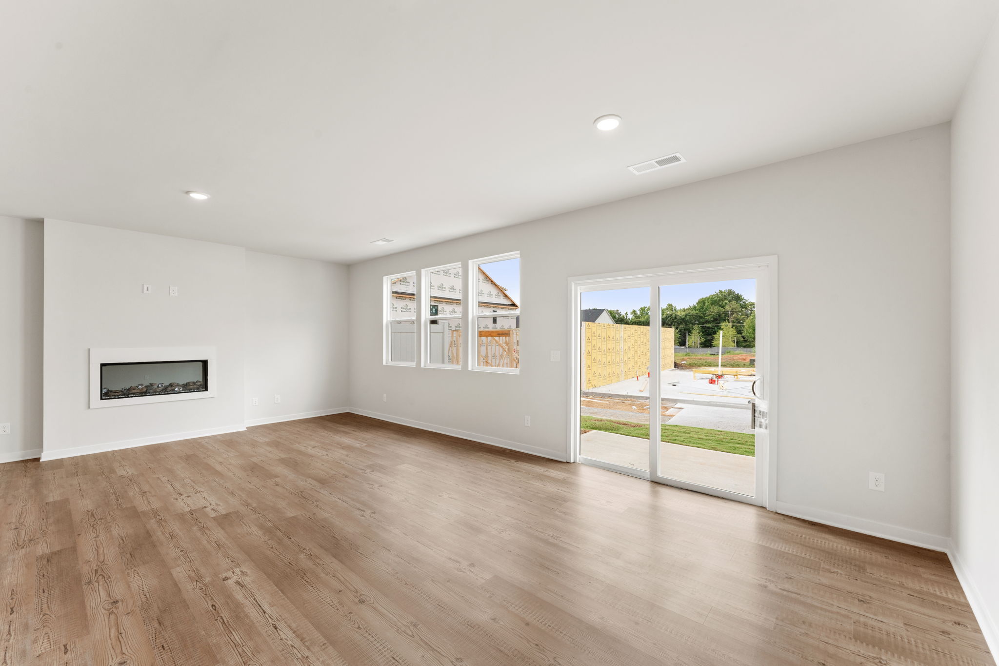 A room with a wood floor and a wood floor with a door.