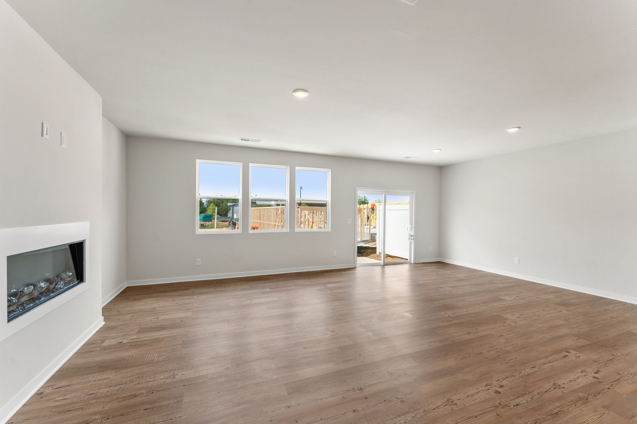 A room with a wood floor and windows.