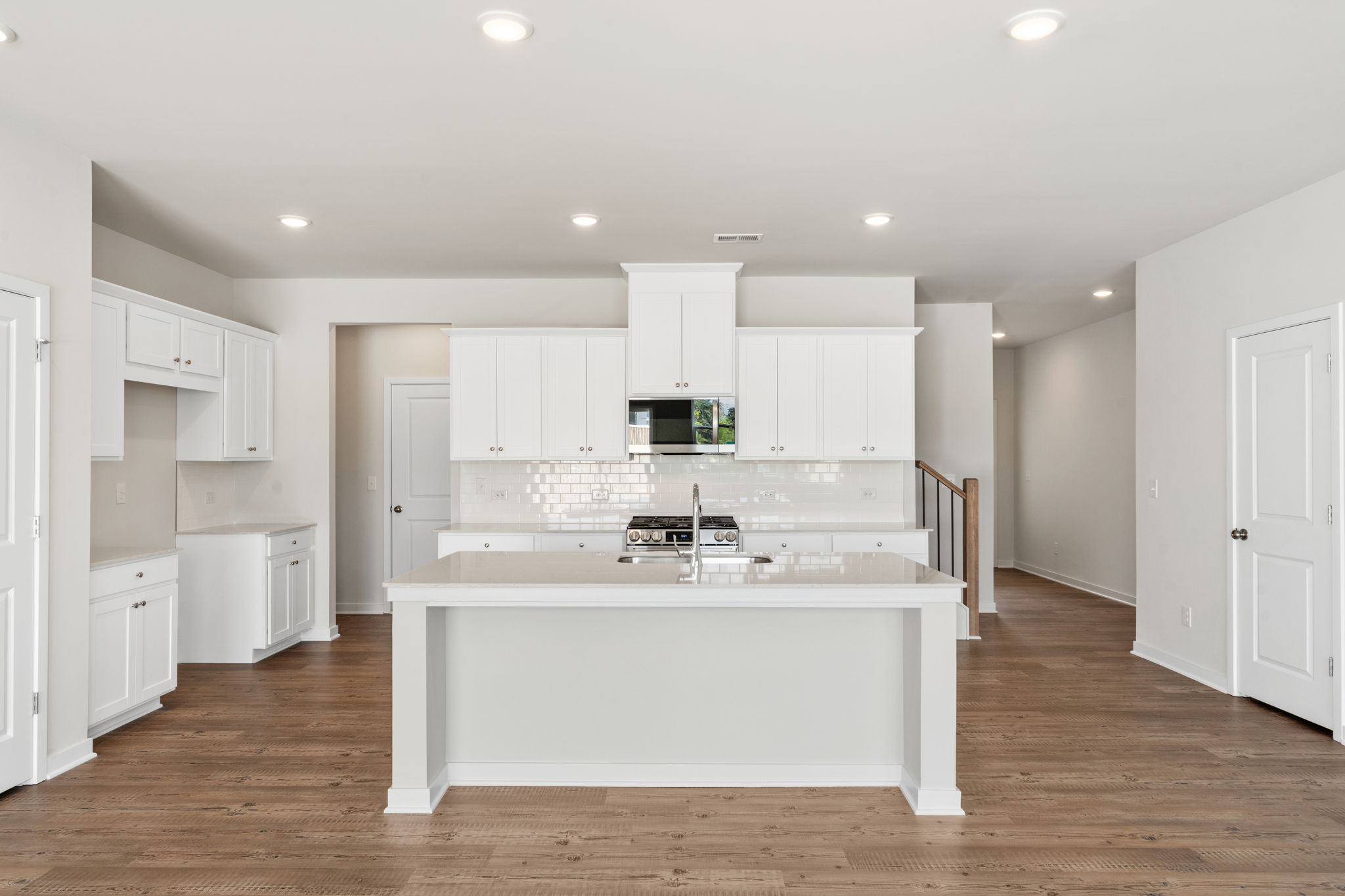 A kitchen with white cabinets.
