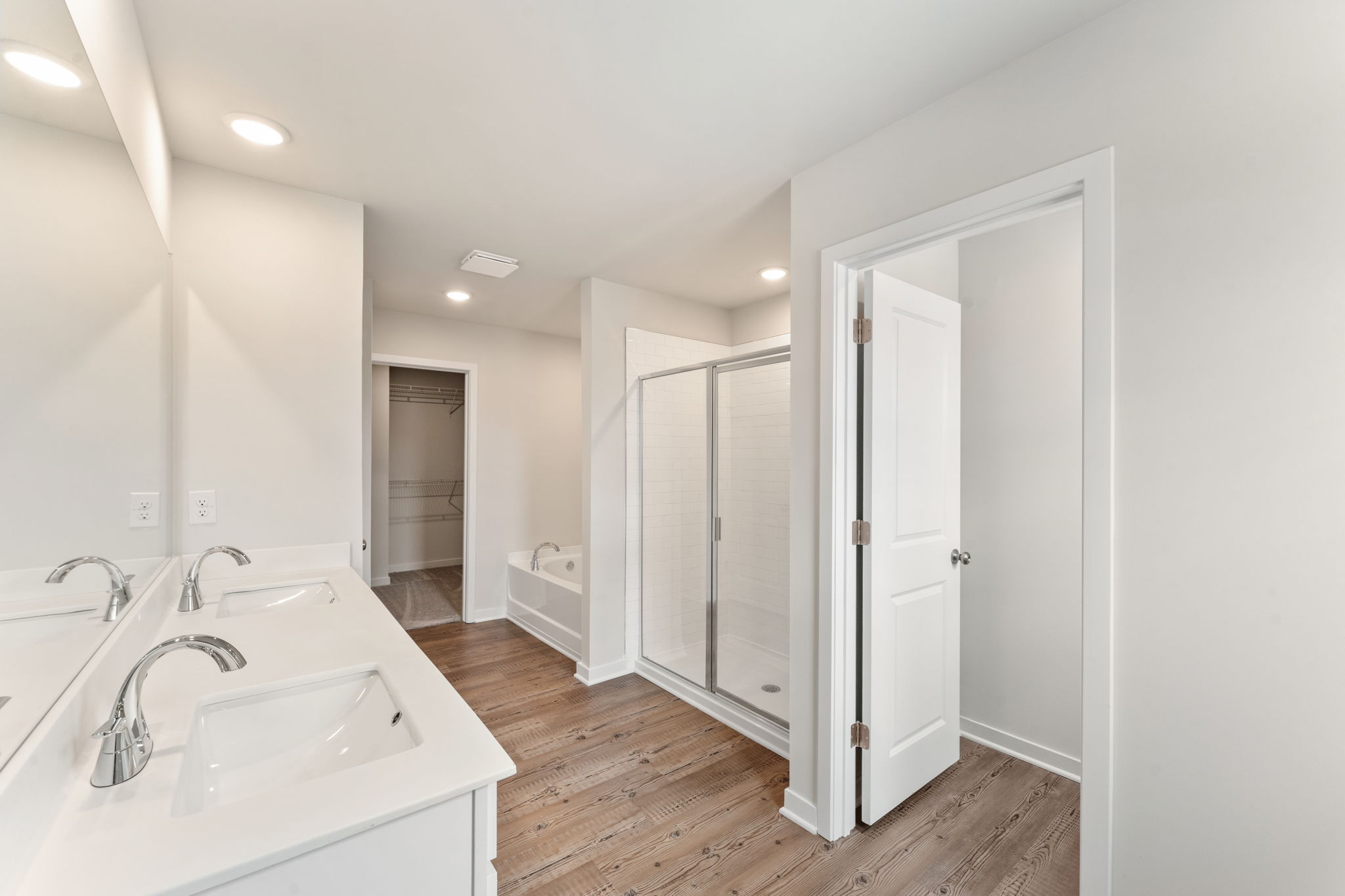 A bathroom with white cabinets.