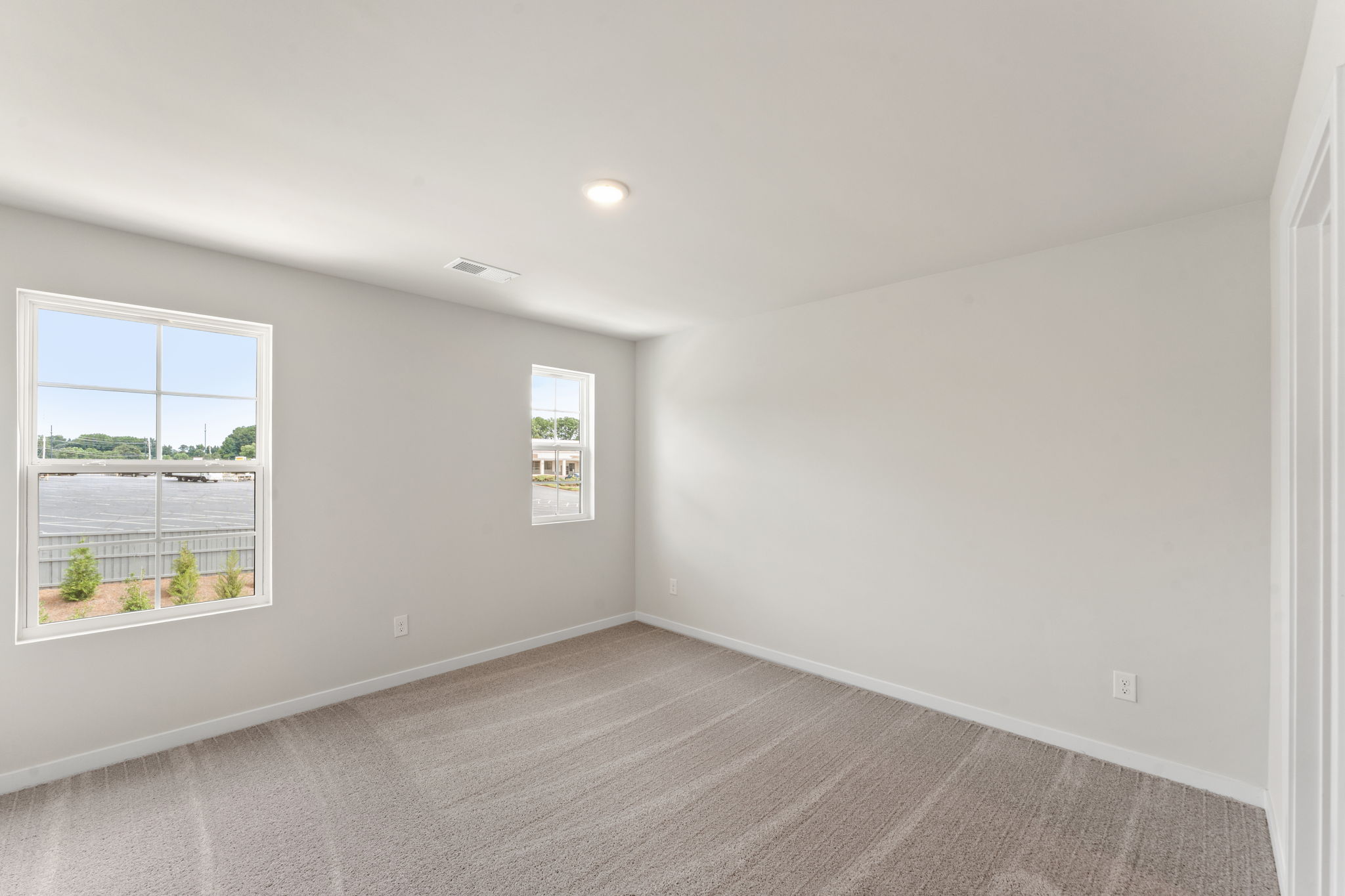 A room with a window and a carpet.