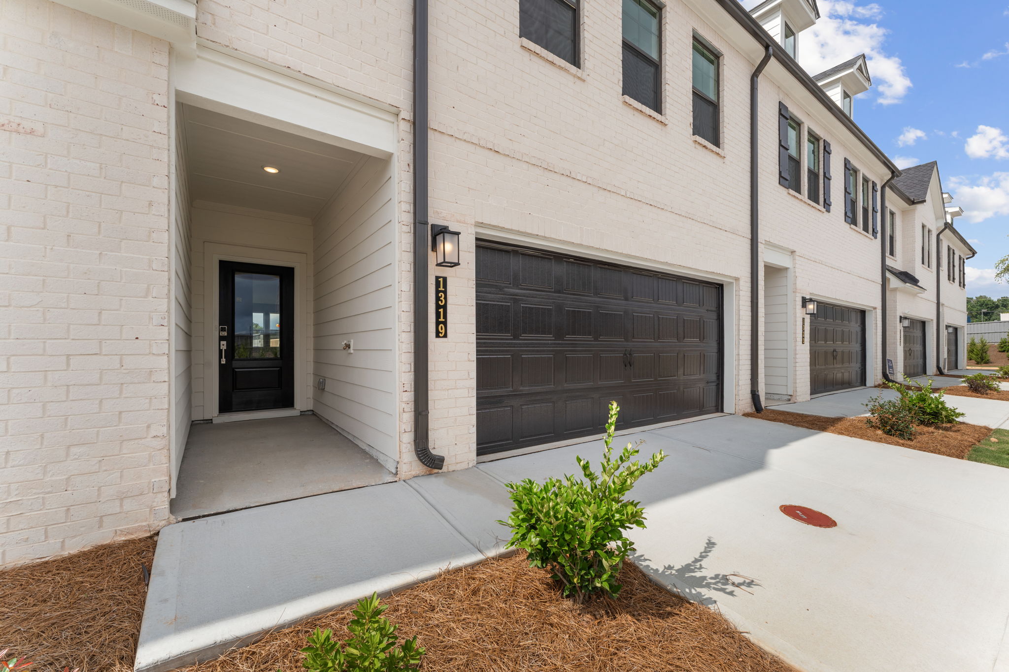 A white building with a garage.