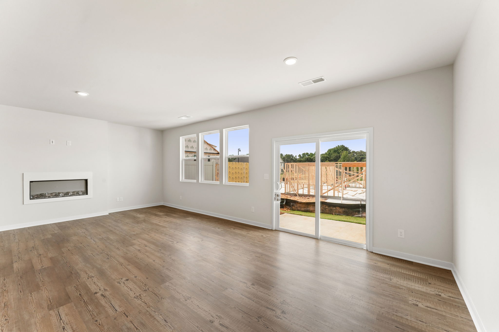 A room with a wood floor and a wood floor with a door.