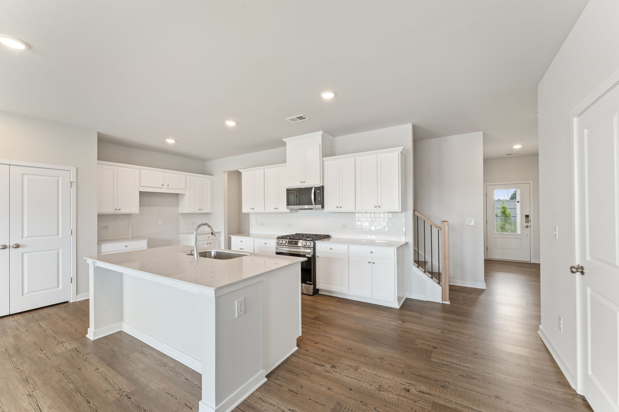 A kitchen with white cabinets.