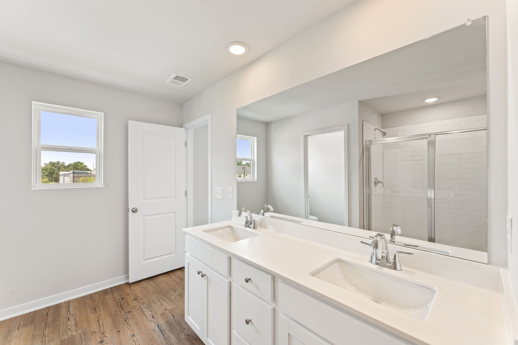 A bathroom with a large mirror.