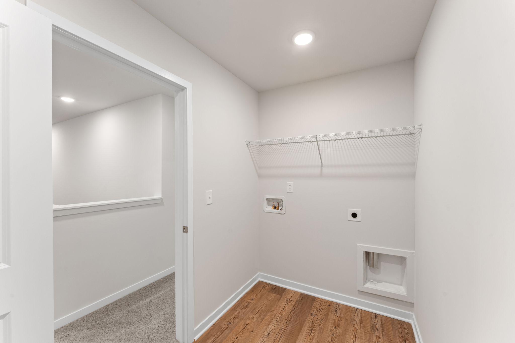 A room with a wood floor and a white door.