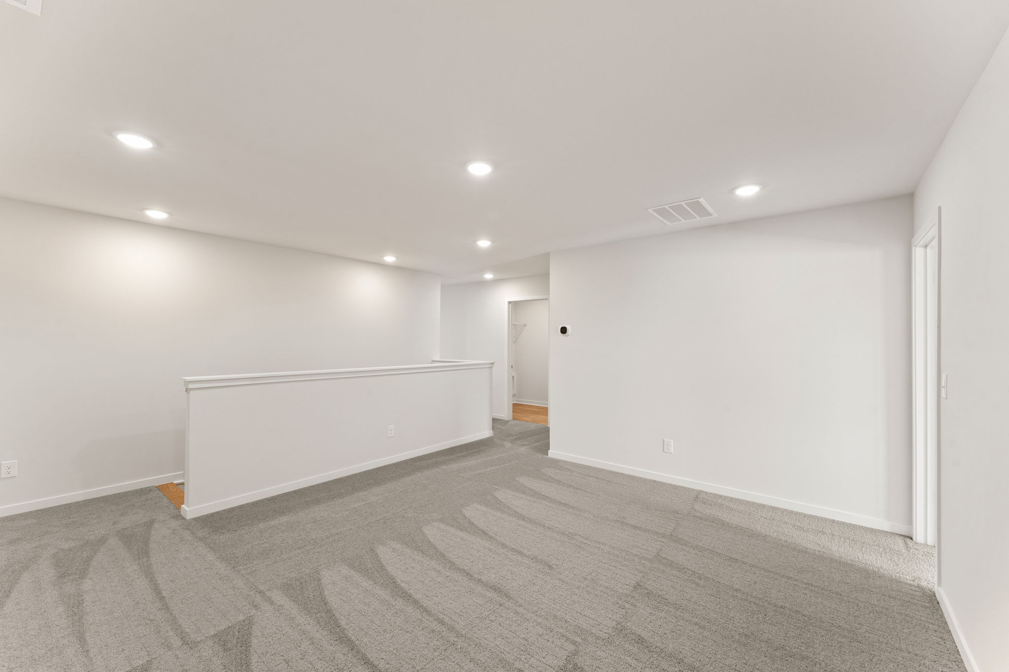 A room with a white wall and a white floor.