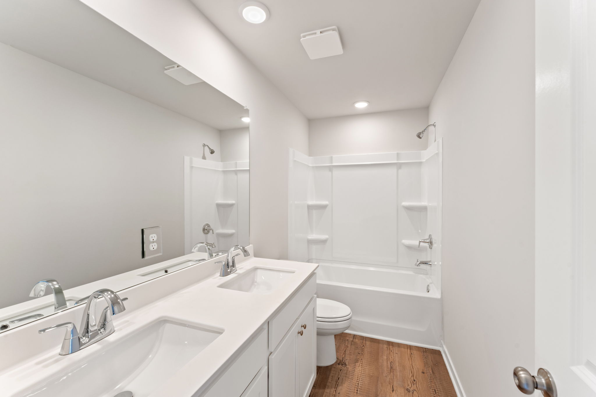A bathroom with a tub sink and toilet.
