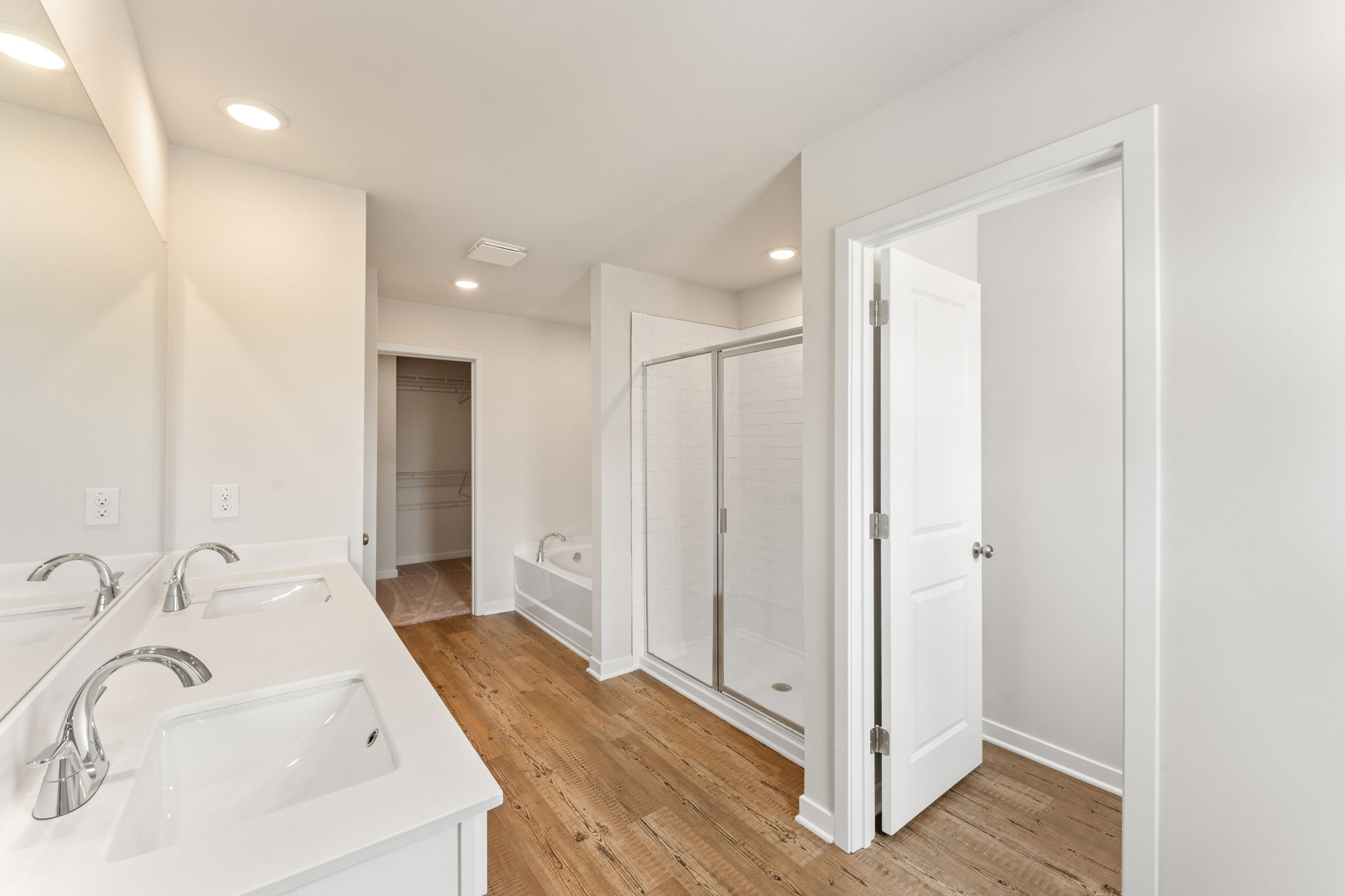 A bathroom with white cabinets.