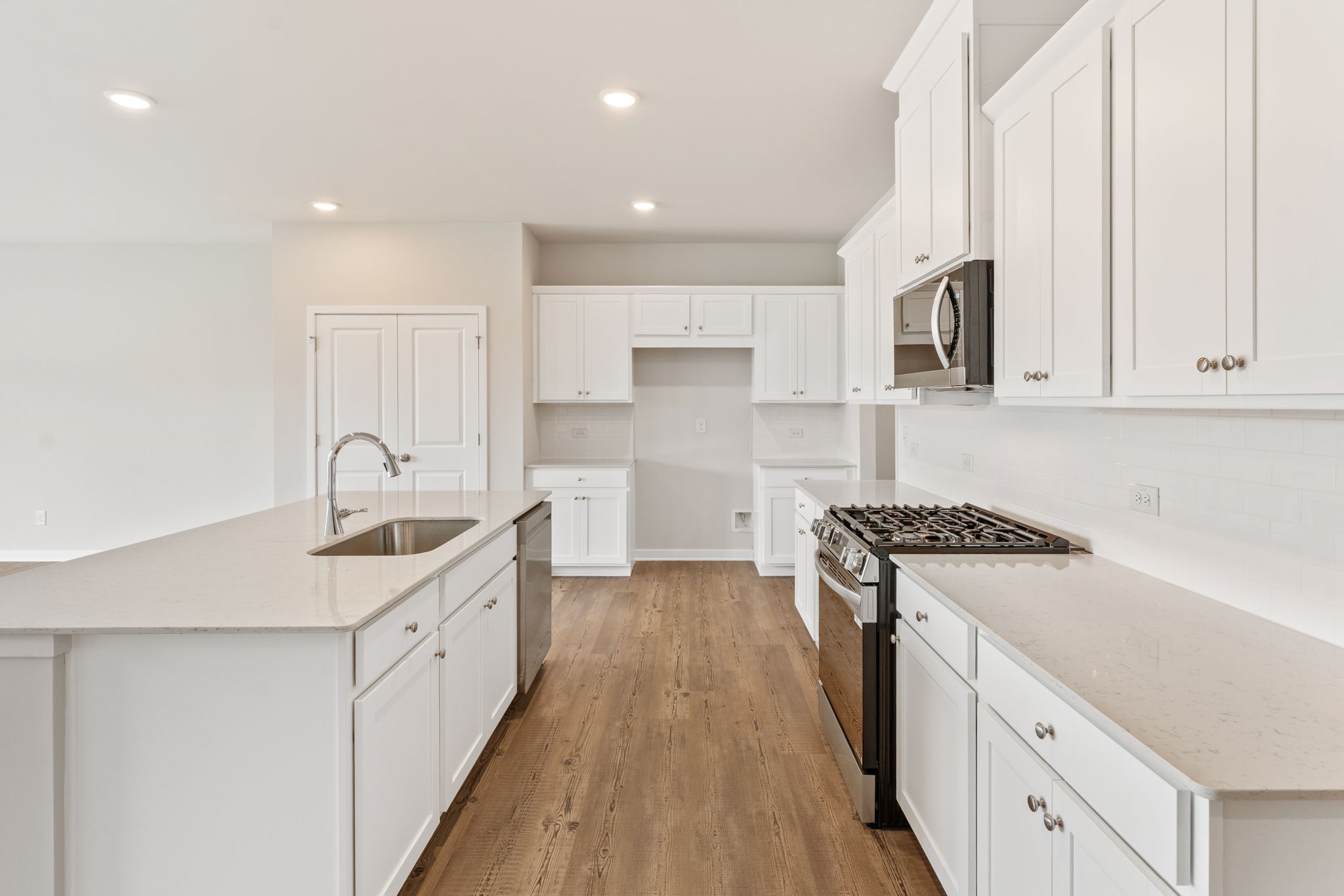 A kitchen with white cabinets.