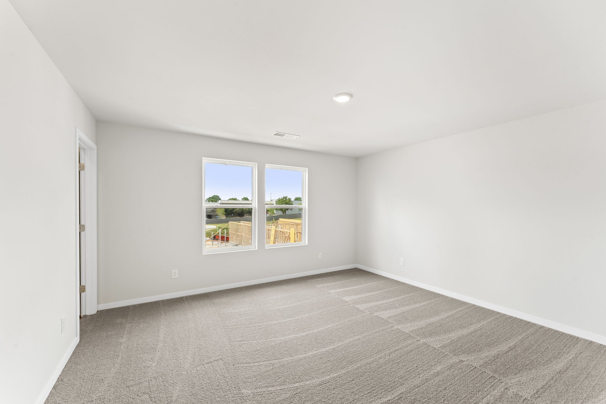 A room with a window and a carpet.
