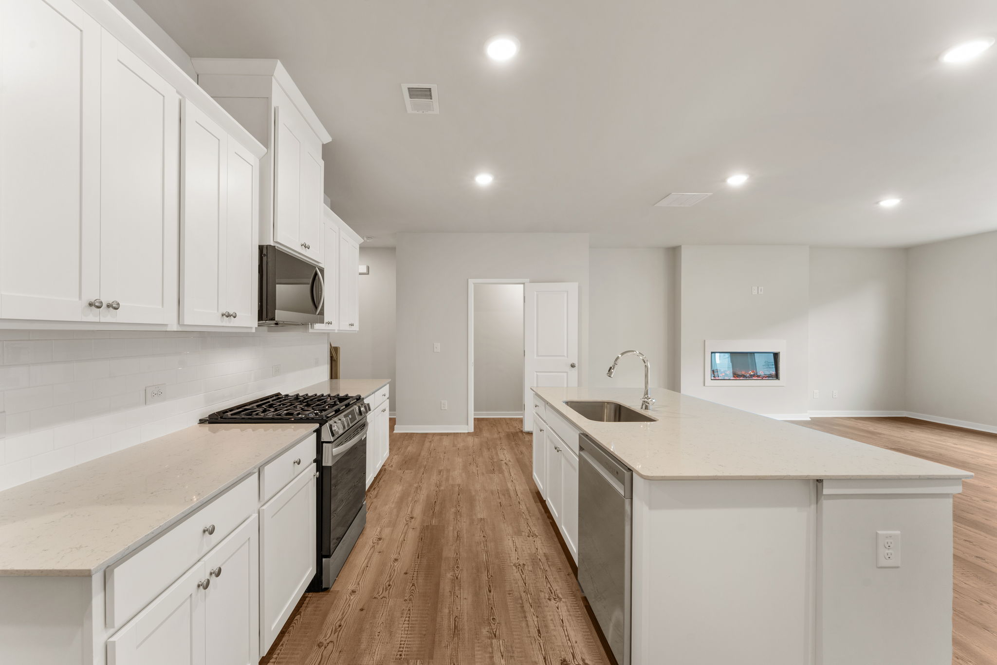 A kitchen with white cabinets.