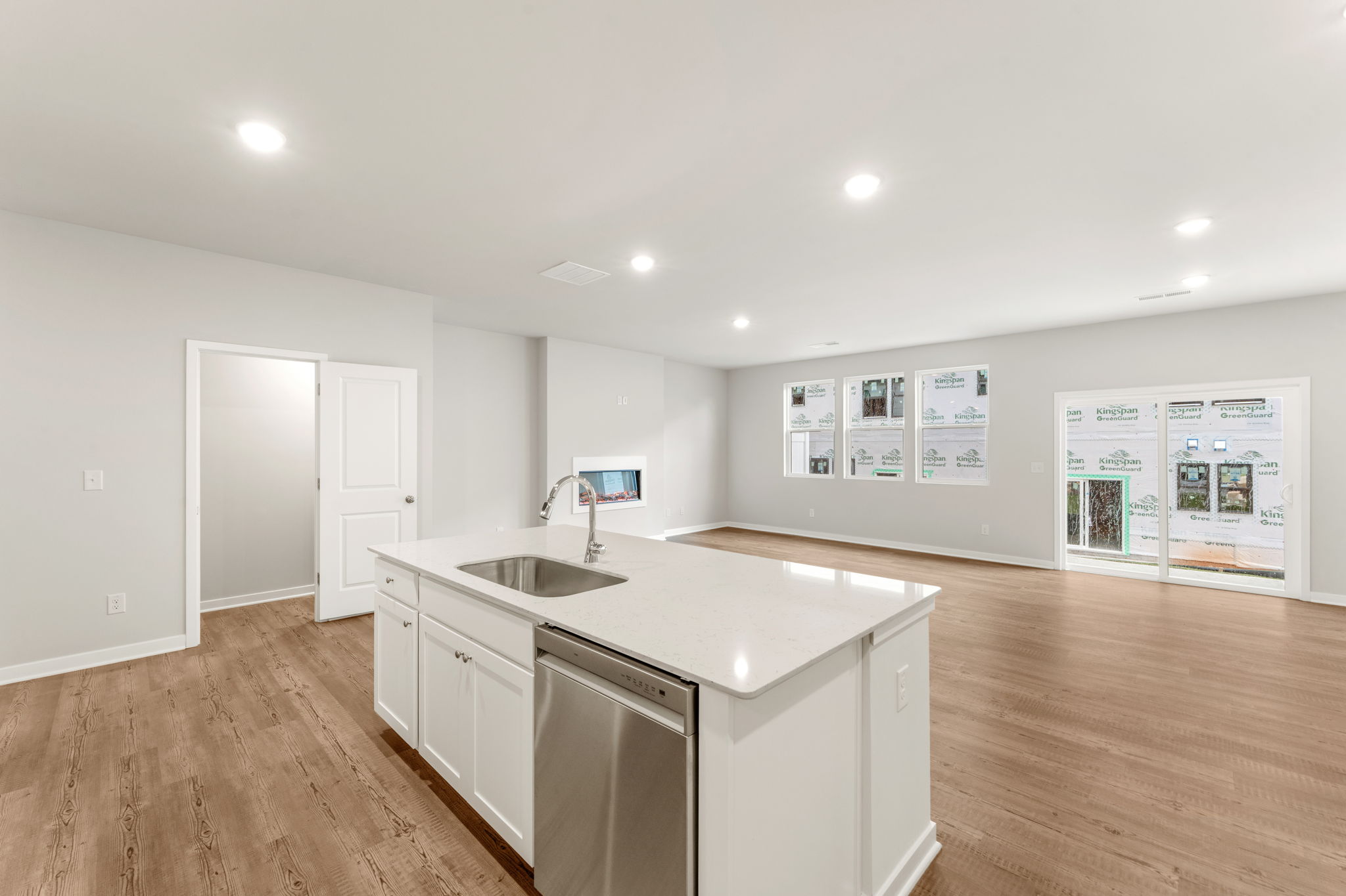 A kitchen with white cabinets.