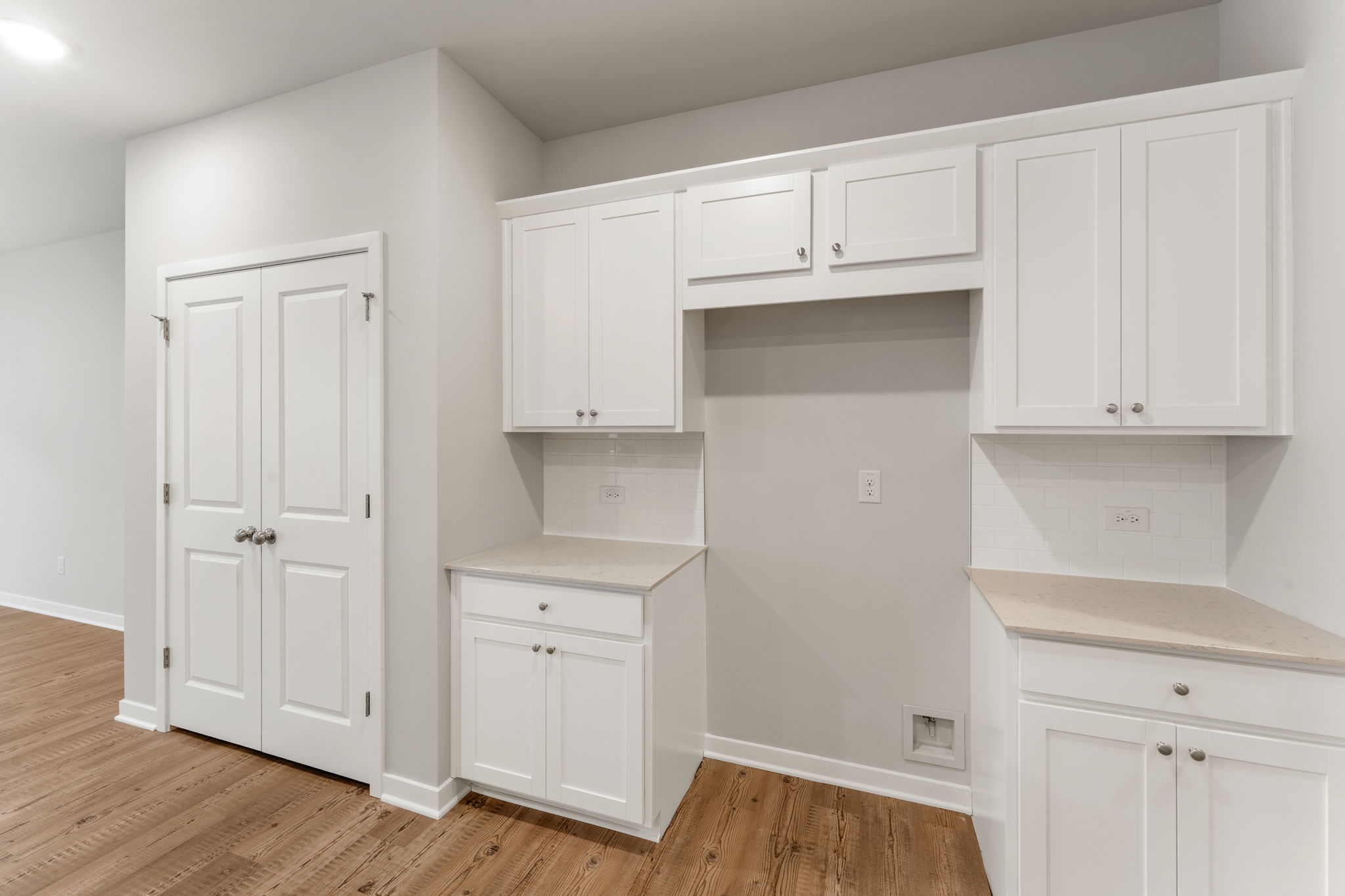 A room with white cabinets.