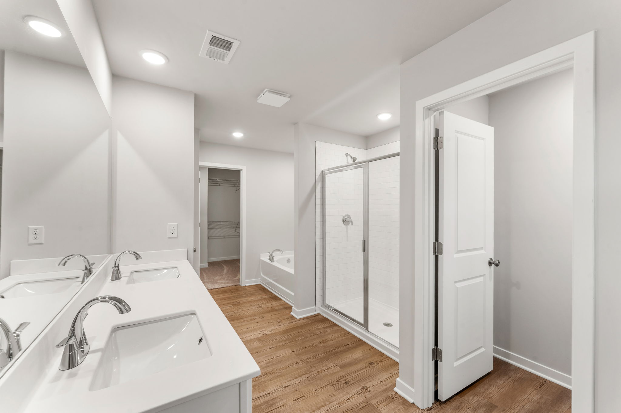 A bathroom with white cabinets.