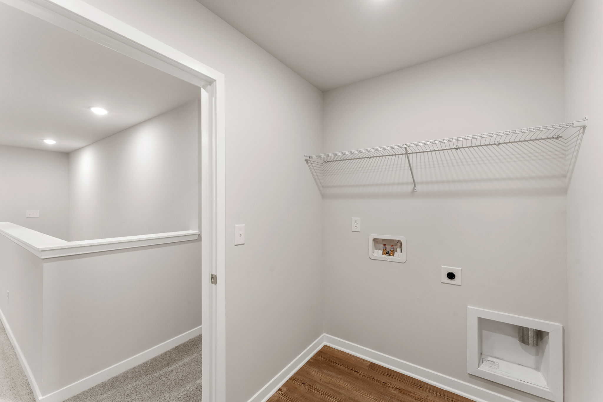 A white room with a shower unit.